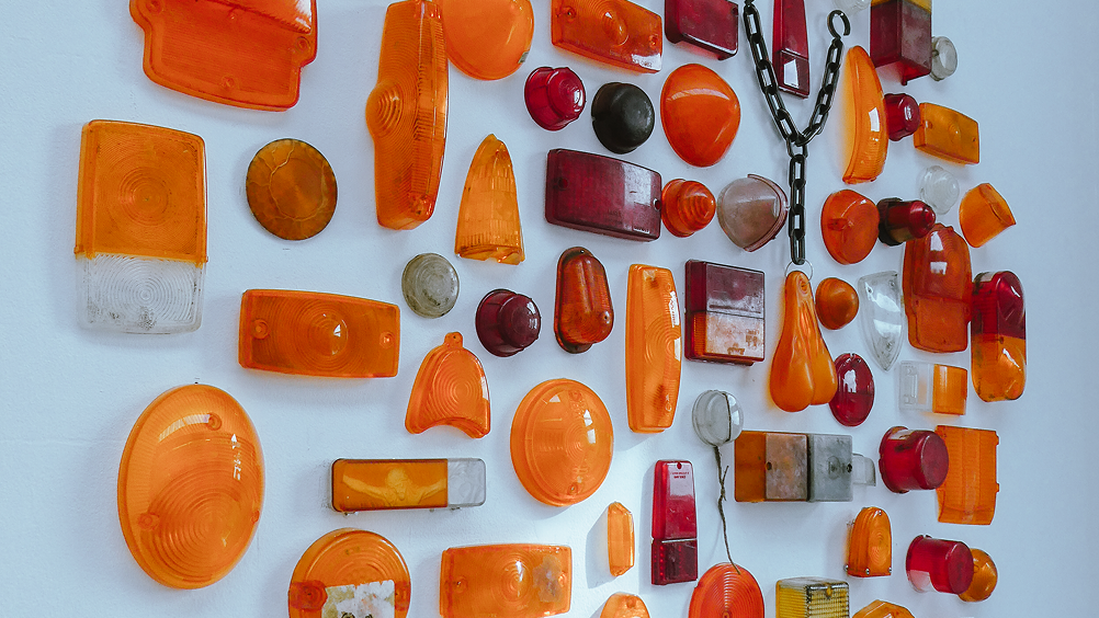 Close view of the wall installation made from amber, red and clear automotive lenses